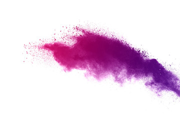 Freeze motion of color powder exploding on white background.