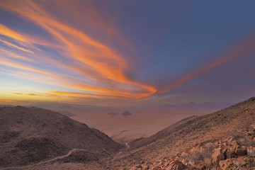 Pink and orange colored clouds at sunset