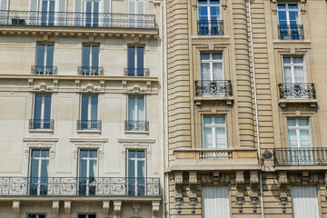 Paris residential buildings. Old Paris architecture, beautiful facades, typical french houses. Famous travel destinations in Europe. Backgrounds. City life, lifestyle and expensive real estate concept