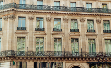 Paris residential buildings. Old Paris architecture, beautiful facades, typical french houses. Famous travel destinations in Europe. Background. City life, lifestyle and expensive real estate concept