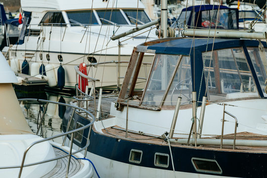 Luxury yachts moored in marina. Boats reflected in the water of Deauville harbor, France. Close up. Yachting, vacation, luxury lifestyle and wealth concept