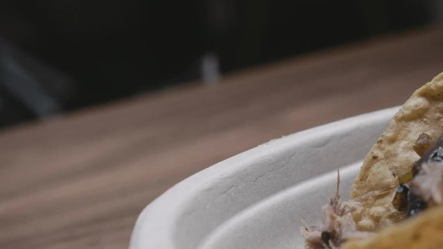 Slow motion footage in 4k of cat standing by carnitas Tacos from chipotle Mexican grill