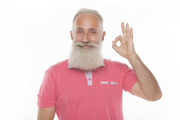 senior funny bearded man in pink t-shirt is shows gestures and grimaces.