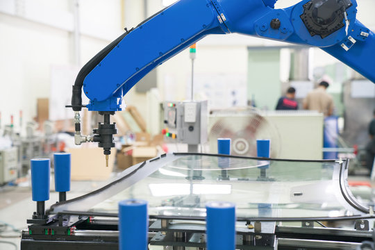 Industrial Automated Robot Arm Holding Car Glass In Factory