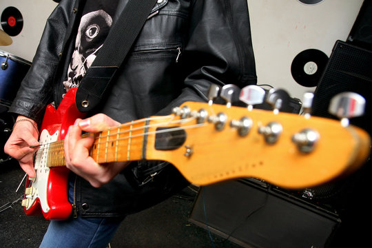 Young musician playing electric guitar
