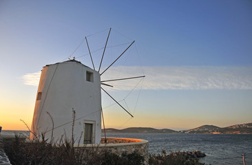 Fototapeta na wymiar Traditional mediterranean greek windmill on sunset