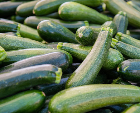 Stacks of green zucchini at the farmers market