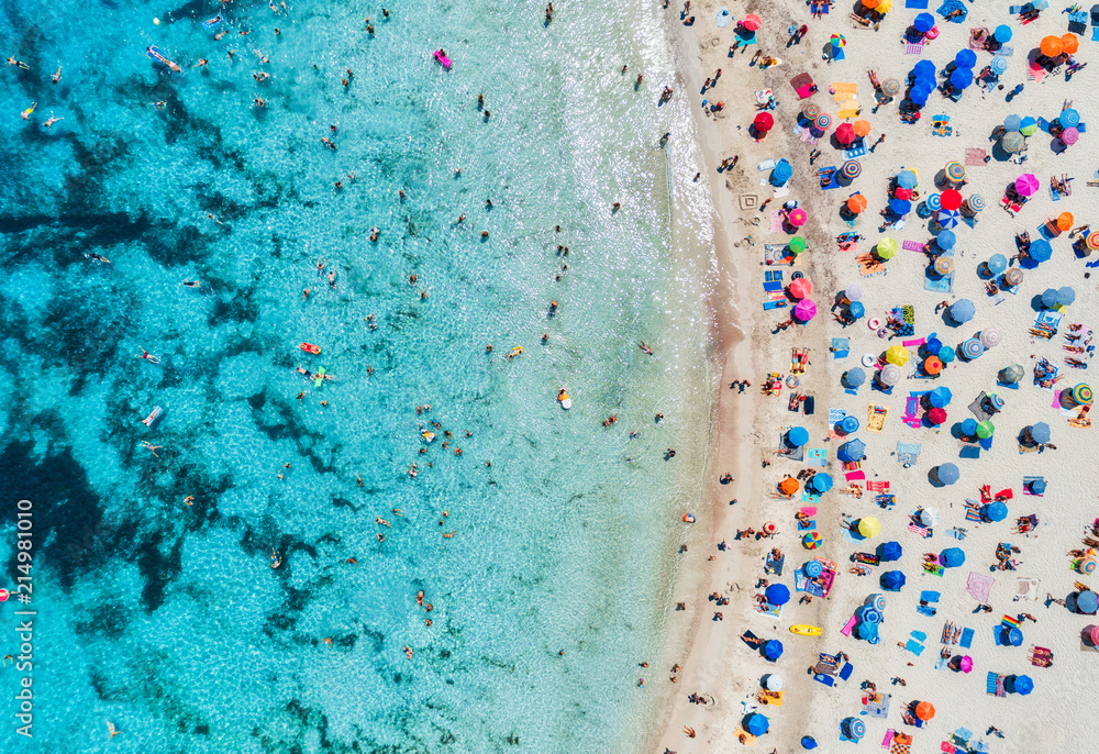 Canvas Prints Aerial view of sandy beach with colorful umbrellas, swimming people in sea bay with transparent blue water in sunny day in summer. Travel in Mallorca, Balearic islands, Spain. Top view. Landscape