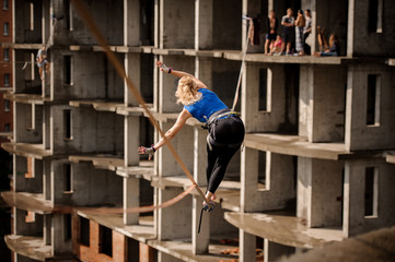 Rear view woman bending to the right on the slackline rope