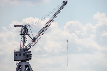 Port industrial crane and sky with clouds