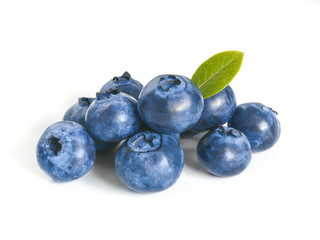 Blueberries isolated on white background. Extreme close up view of heap blueberry berries with green leaf. Isolated on white with clipping path.