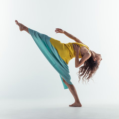 Beuatiful female dancer. Studio background.