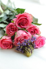 bouquet of pink roses on white background with other kind of flowers 