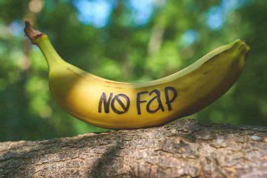 Banana with inscription "nofap" on stump like mens penis. Concept sexual problems.