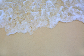 Fototapeta na wymiar Closeup view of clear ocean water coming up on white sand. Beautiful nature background. Sand texture.