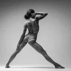 Young beautiful yoga woman is posing in studio. Black and white