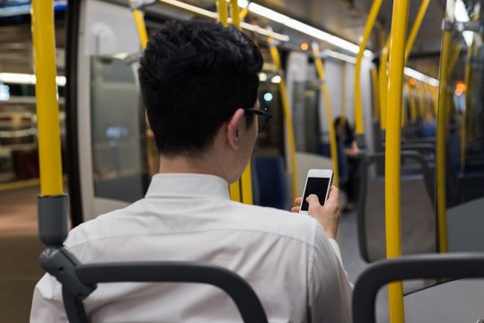 Man using mobile phone while travelling in train
