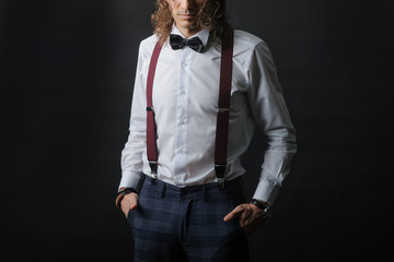 Young handsome boy in white shirt with tie and glases, hands in pockets