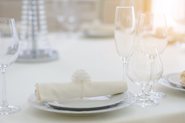 The banquet hall with round tables, with cutlery