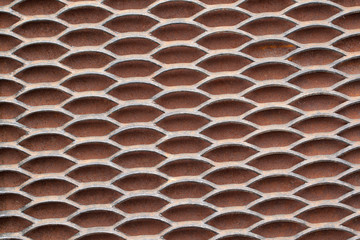 Metal solid grating with holes creating a rhythmic pattern