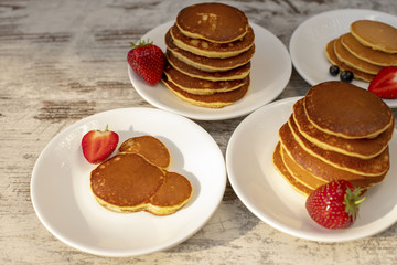 Pancakes with fruit. Breakfast with punkcakes. Pancakes in a pile on a plate.