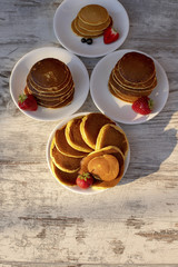Pancakes with fruit. Breakfast with punkcakes. Pancakes in a pile on a plate.