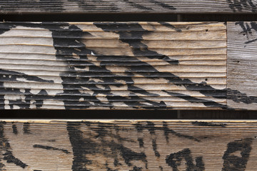 Wood fence slats with burned markings
