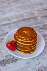 Pancakes with fruit. Breakfast with punkcakes. Pancakes in a pile on a plate.
