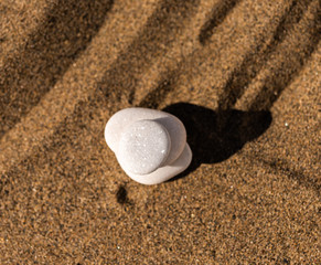 zen meditation stone in sand, concept for purity harmony and spirituality, spa wellness and yoga background