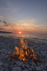 fire burns near the sea