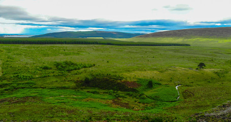 Obraz premium Aerial view over fields in the Scottish Highlands