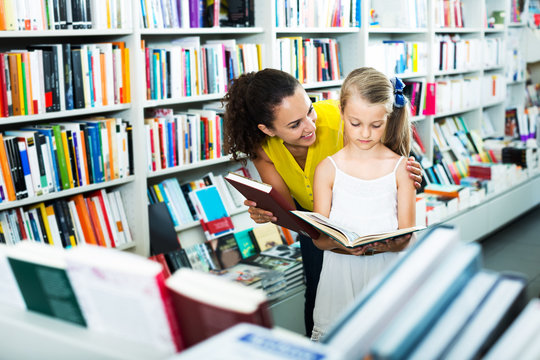 Mother with daughter in bookstore