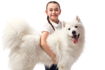 Happy child with white dog. Portrait girl with pet. Smilyng Samoyed Laika dog.