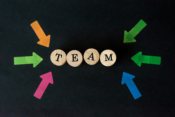 Word team written with wooden blocks on black background