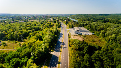 Fototapeta na wymiar Aerial view of asphalt road passes through forest.