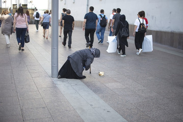 Beggar. The old woman asks for money on the street. Poor old woman begging on the street from...