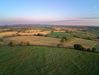 Aerial view on cheshire plains and fields. Summer sunset behind
