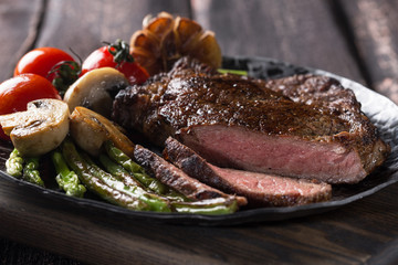 Grilled ribeye beef steak, herbs and spices. Top view.