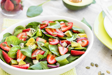 Healthy salad with avocado, strawberry and spinach. Clean eating.
