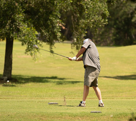 unknown golfer has a powerful swing