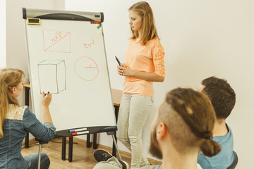 Teacher teaching mathematics to college students