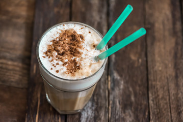 Cup of Coffee with Cream on Wooden Background