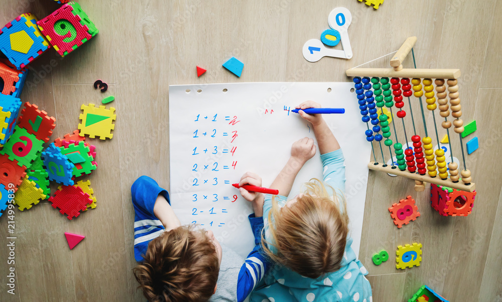 Wall mural little boy and girl learn to write and calculate numbers