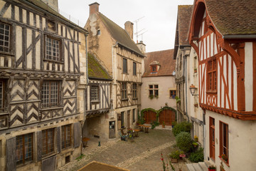 Fototapeta na wymiar Square with half-timbered houses, in the medieval village Noyers-sur-Serein