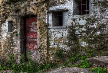 Abandoned stone house built on a hill