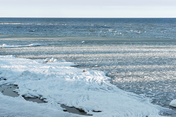 The sea is frozen. Pier in the ice. Sea coast in the ice in the winter. The frozen Baltic Sea.