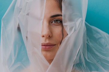 Portrait of a woman wrapped in transparent plastic