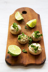 Mushroom and chicken puree with lime on rustic wooden board, low angle.