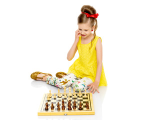 Little girl playing chess