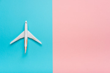 Top view of an airplane on trendy color background.  Bright summer color. Travel concept.